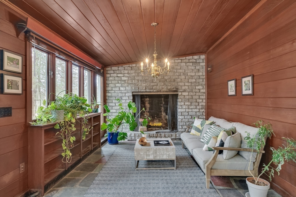 215 Mossman Road Sudbury, MA 01776 - Photo 19 of 30 a living room with patio furniture and a fireplace