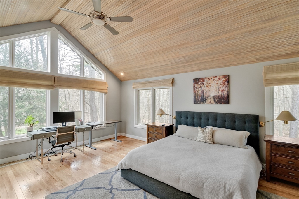 215 Mossman Road Sudbury, MA 01776 - Photo 20 of 30 a large bedroom with a large bed and large windows