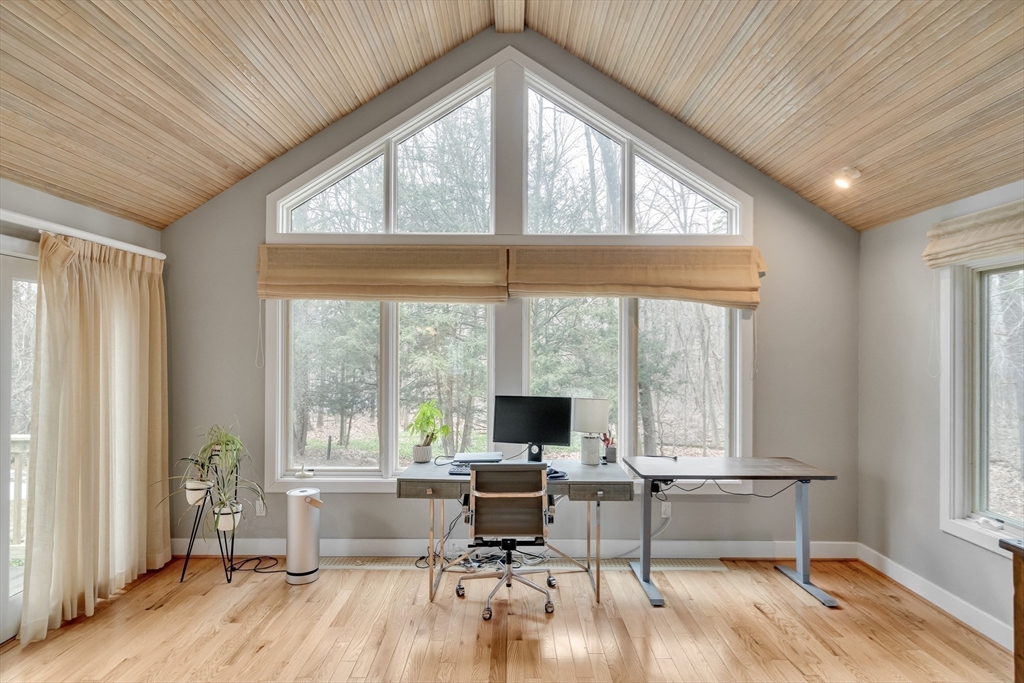 215 Mossman Road Sudbury, MA 01776 - Photo 21 of 30 a living room with furniture large window and wooden floor