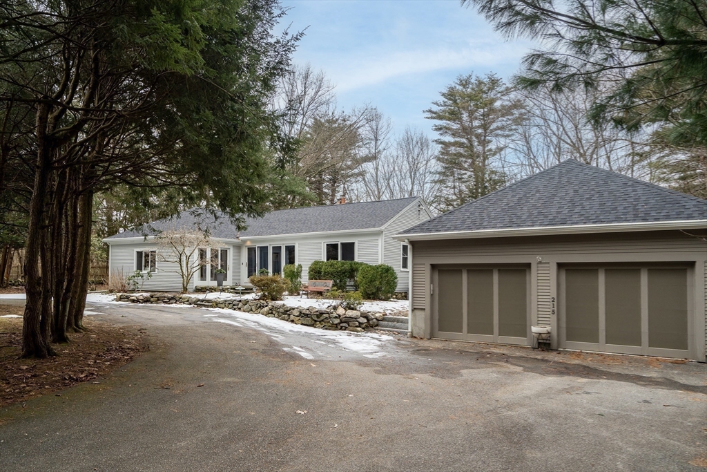 215 Mossman Road Sudbury, MA 01776 - Photo 29 of 30 a front view of a house with a yard and garage