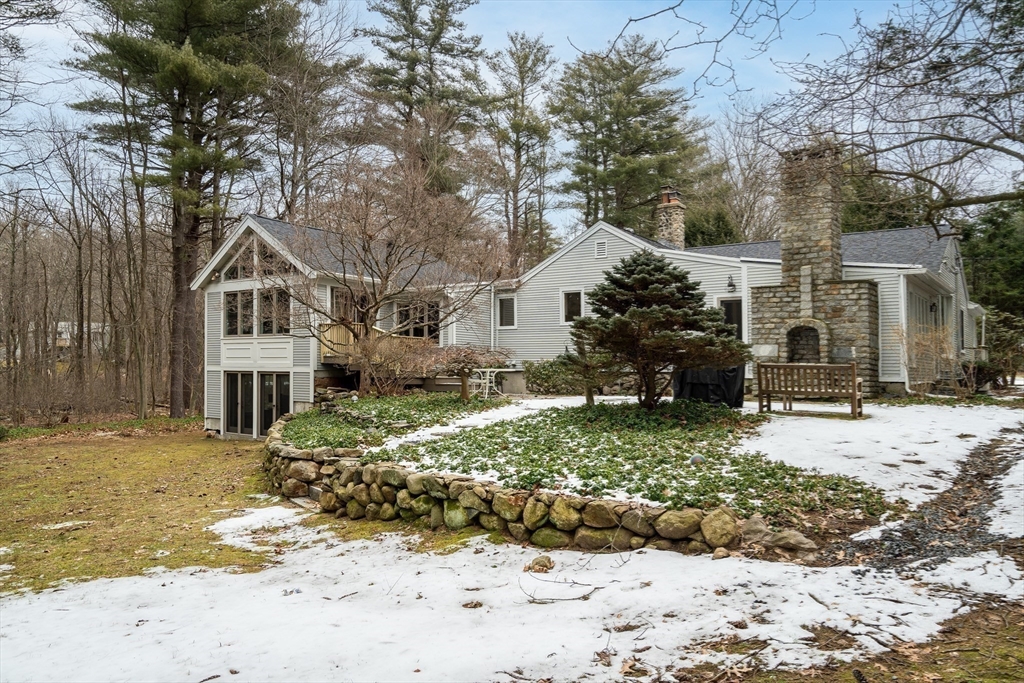 215 Mossman Road Sudbury, MA 01776 - Photo 30 of 30 a front view of a house with a yard covered in snow