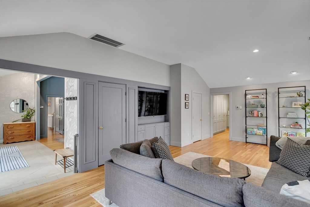 215 Mossman Road Sudbury, MA 01776 - Photo 4 of 30 a bedroom with furniture and a flat screen tv