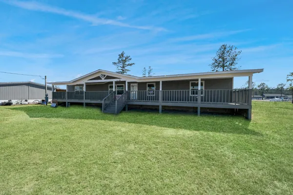 a view of a house with a backyard