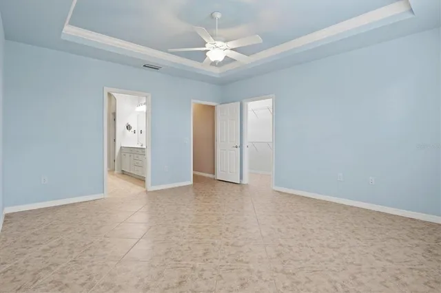 a living room with furniture a dining table and a chandelier