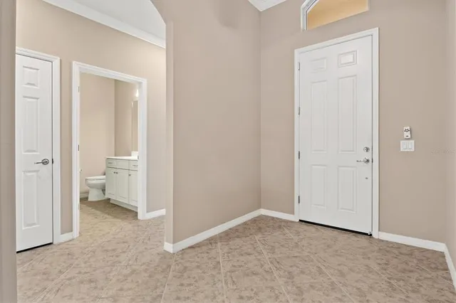 a view of a patio with a table and chairs under an umbrella