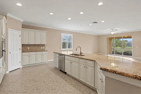 a large kitchen with kitchen island a sink stove and refrigerator