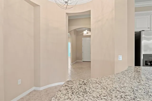a bathroom with a granite countertop double vanity sink a mirror and a shower