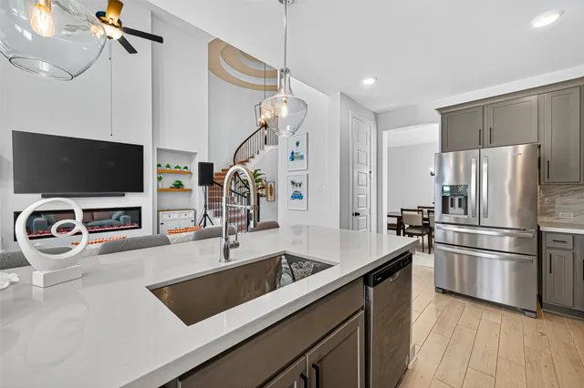 a kitchen that has a kitchen island wooden floor and a sink
