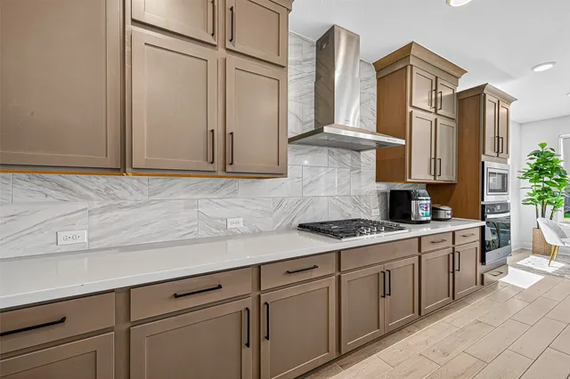 a kitchen with stainless steel appliances granite countertop a sink a stove and cabinets