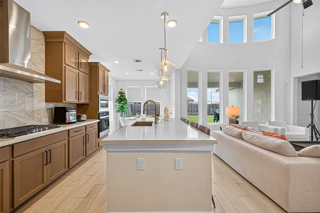 a kitchen with kitchen island granite countertop a sink stove and cabinets