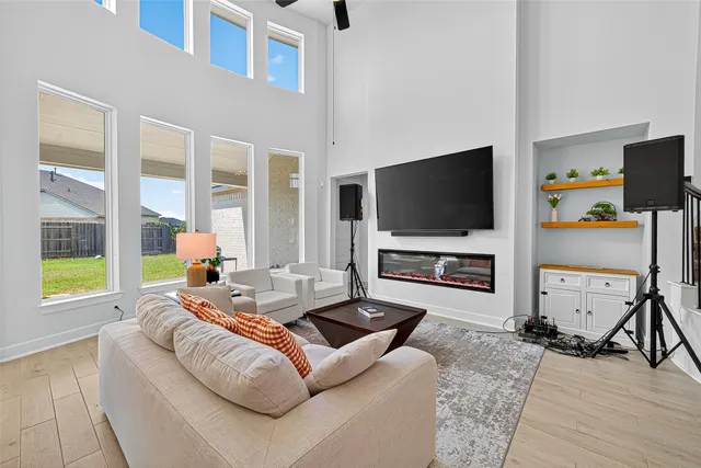 a living room with fireplace furniture and a flat screen tv