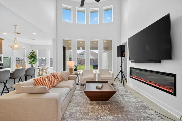 a living room with furniture a flat screen tv and a fireplace