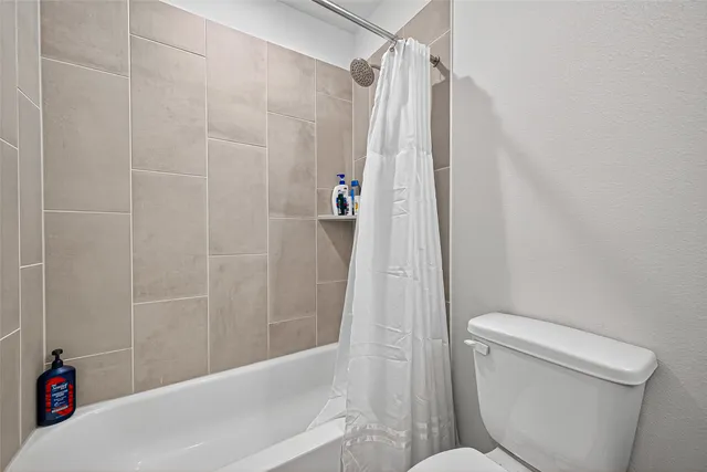 a bathroom with a shower and a toilet