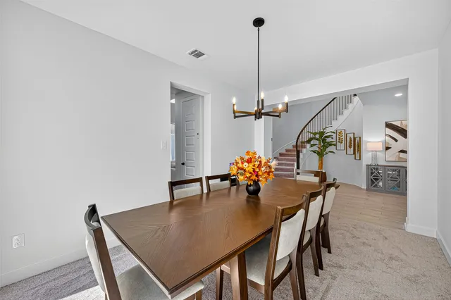 a view of a dining room and a table and chairs