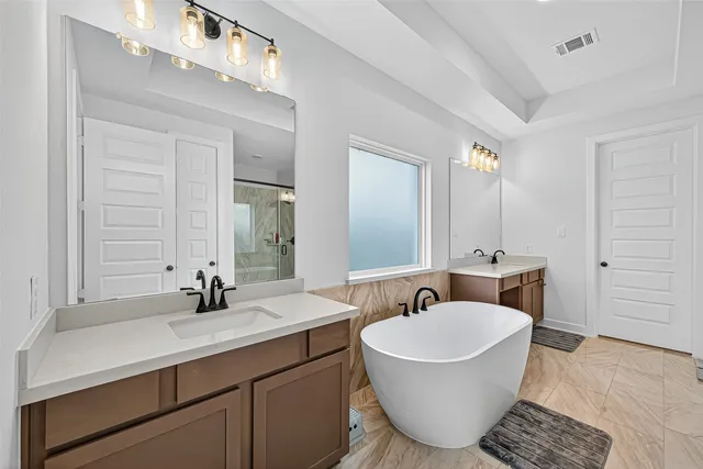 a bathroom with a tub sink and mirror