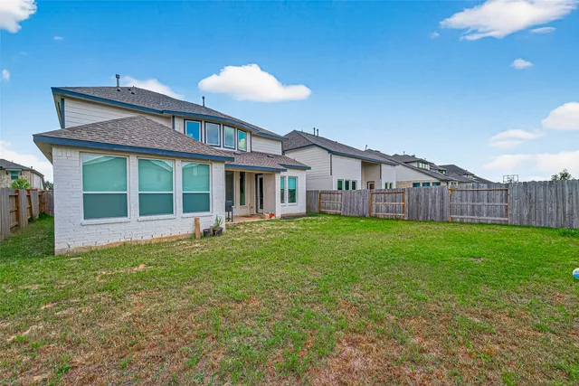 a view of a house with a backyard