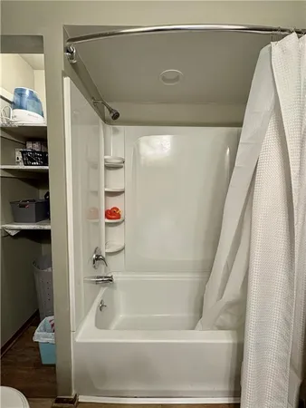 a bathroom with a bathtub and a shower
