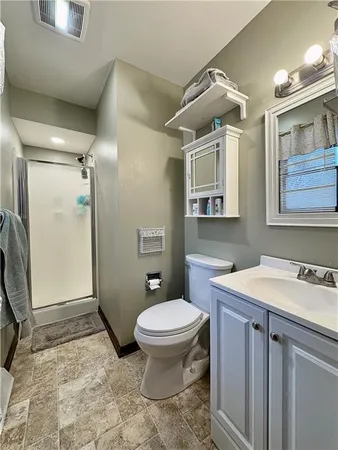 a bathroom with a sink toilet and shower