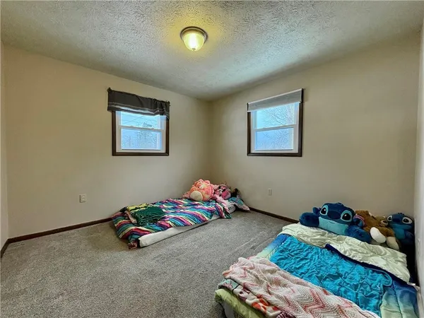 a bedroom with bed and a window