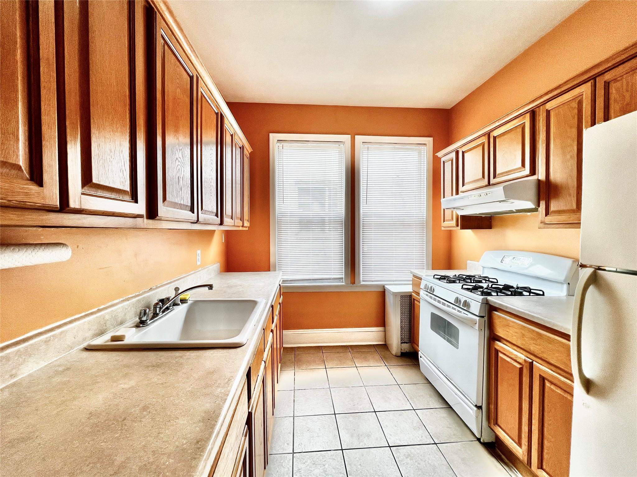 a kitchen that has a sink and a stove