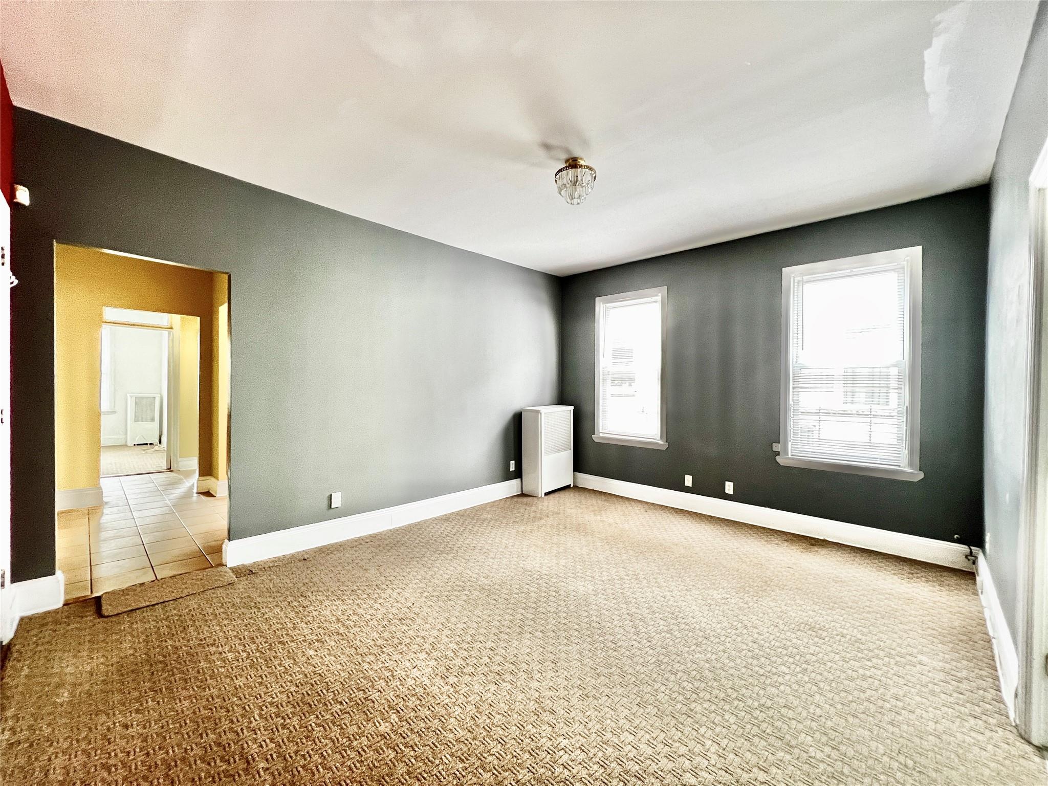 6700 49th Avenue Queens, NY 11377 - Photo 5 of 11 a view of an empty room with a window