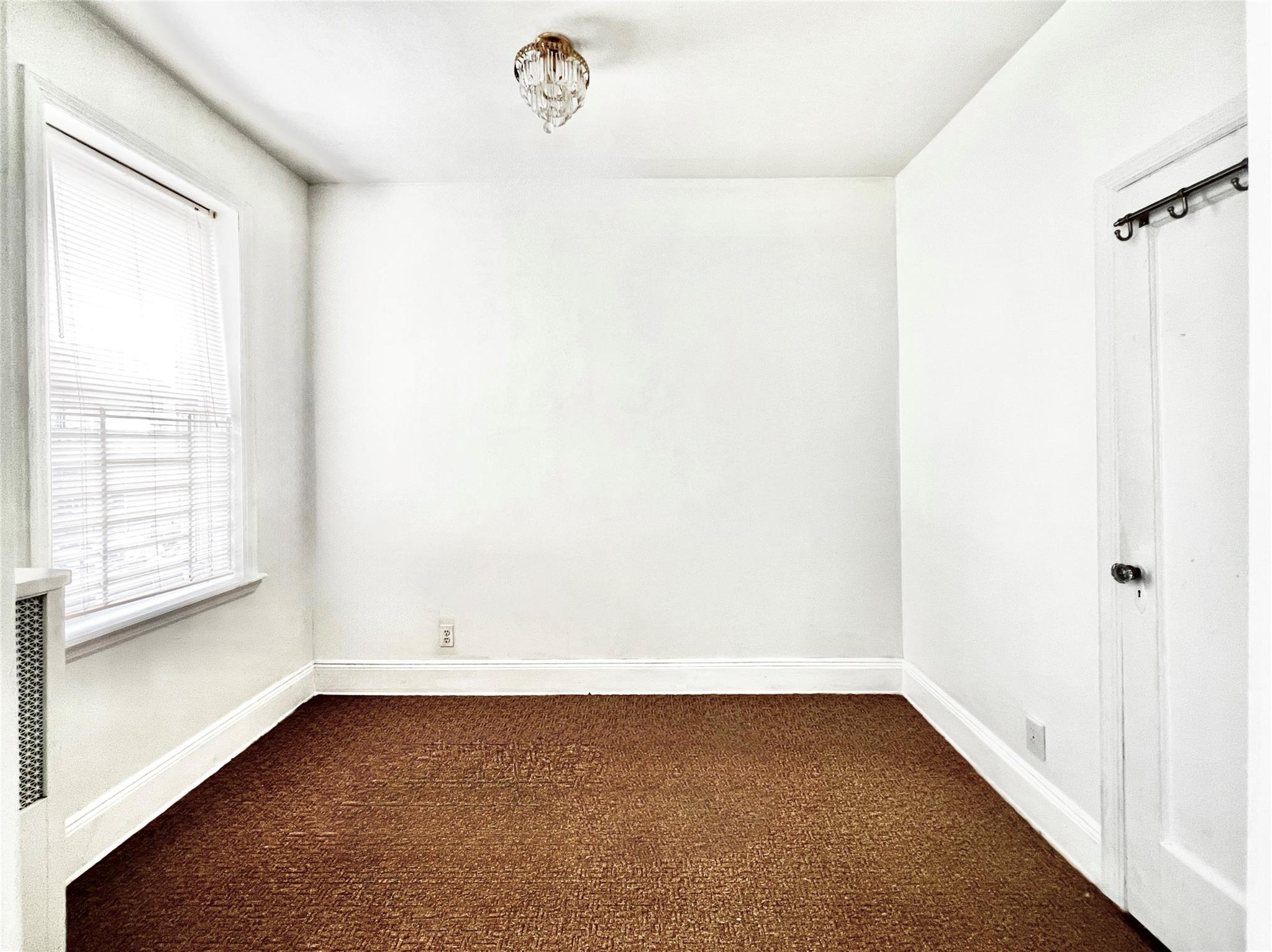 6700 49th Avenue Queens, NY 11377 - Photo 8 of 11 a view of a room that has a window in it