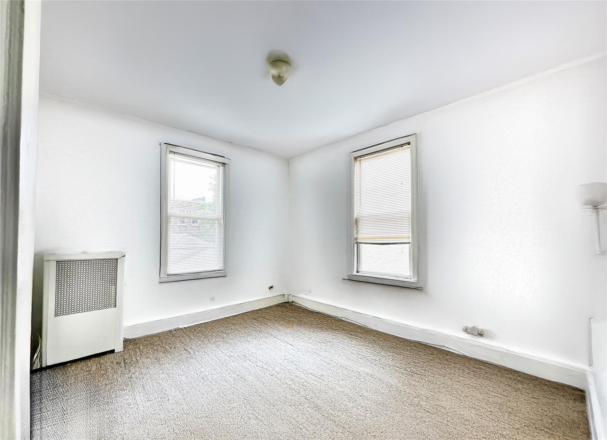 6700 49th Avenue Queens, NY 11377 - Photo 9 of 11 an empty room with a window