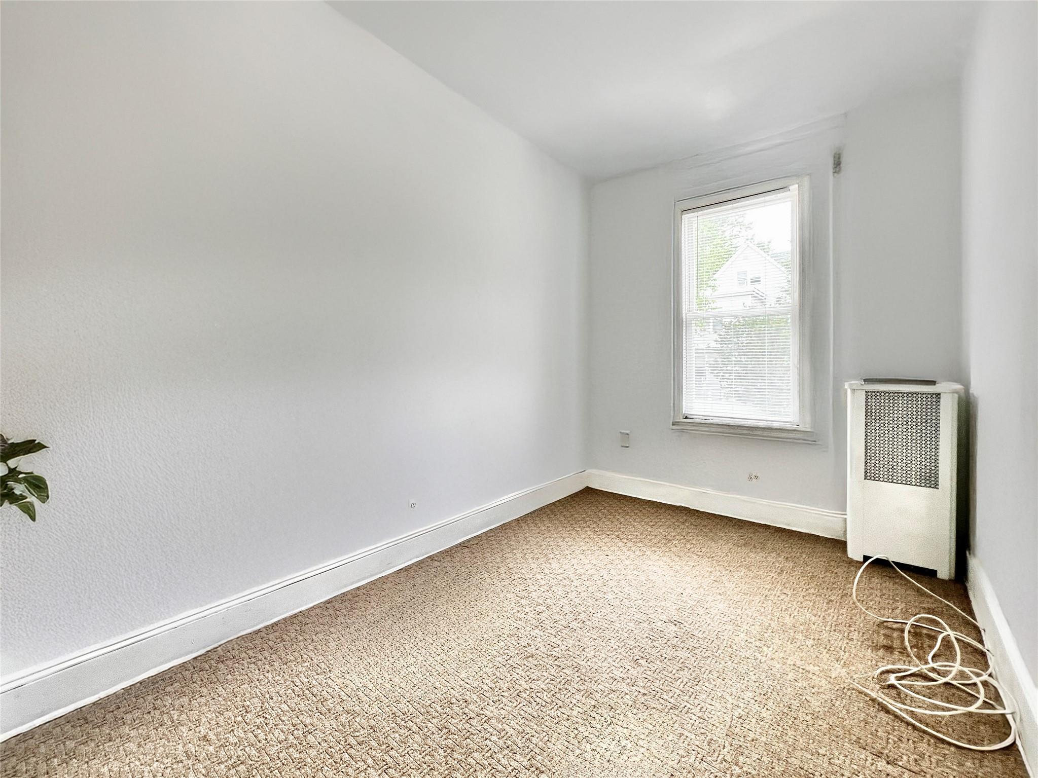 6700 49th Avenue Queens, NY 11377 - Photo 10 of 11 an empty room with windows