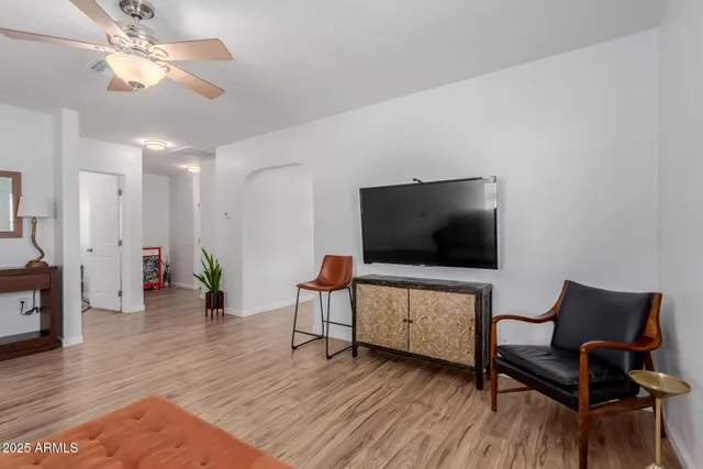 a kitchen with stainless steel appliances granite countertop a stove a sink dishwasher a refrigerator with a dining table and chairs