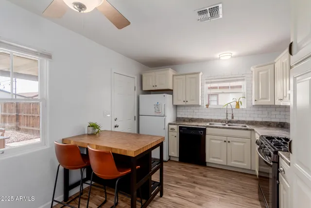 a kitchen with white cabinets and white appliances
