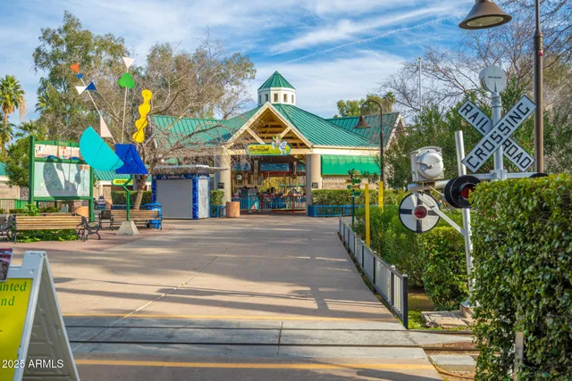 a view of a roof deck with table and chairs under an umbrella with wooden floor