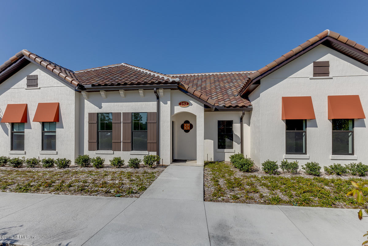 252 Paseo Reyes Drive St. Augustine, FL 32095 - Photo 1 of 15 a front view of a house with garden