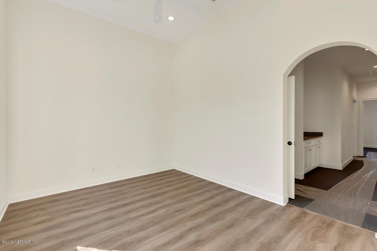 252 Paseo Reyes Drive St. Augustine, FL 32095 - Photo 3 of 15 an empty room with wooden floor and windows