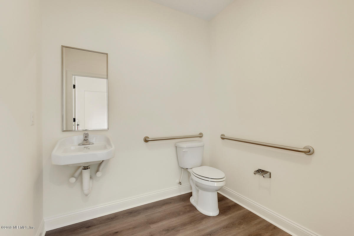 252 Paseo Reyes Drive St. Augustine, FL 32095 - Photo 6 of 15 a white toilet sitting next to a bathroom sink