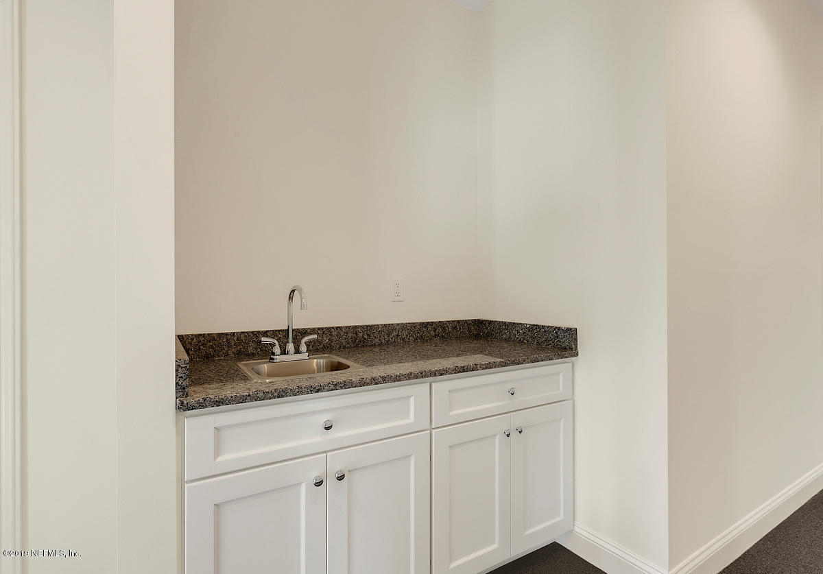 252 Paseo Reyes Drive St. Augustine, FL 32095 - Photo 7 of 15 a bathroom with a granite countertop sink and vanity