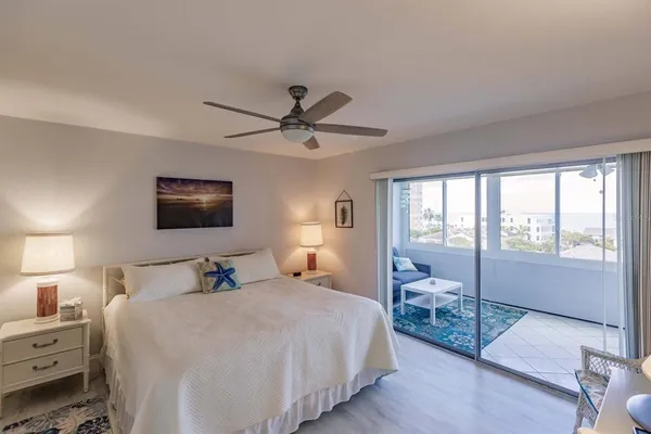 a bedroom with a large bed and a tv