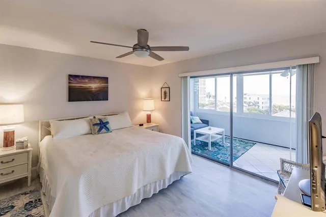 a bedroom with a large bed and a flat tv screen on dresser
