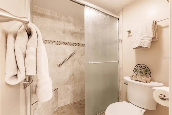 a white toilet sitting next to a bathroom