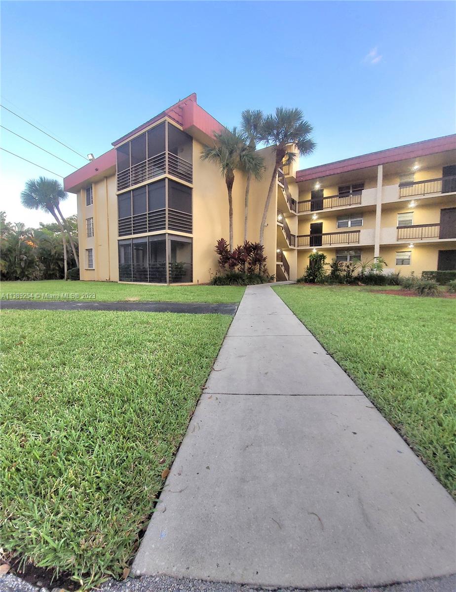 3490 Foxcroft Road, Unit B202 Miramar, FL 33025 - Photo 2 of 29 a front view of a building with a yard