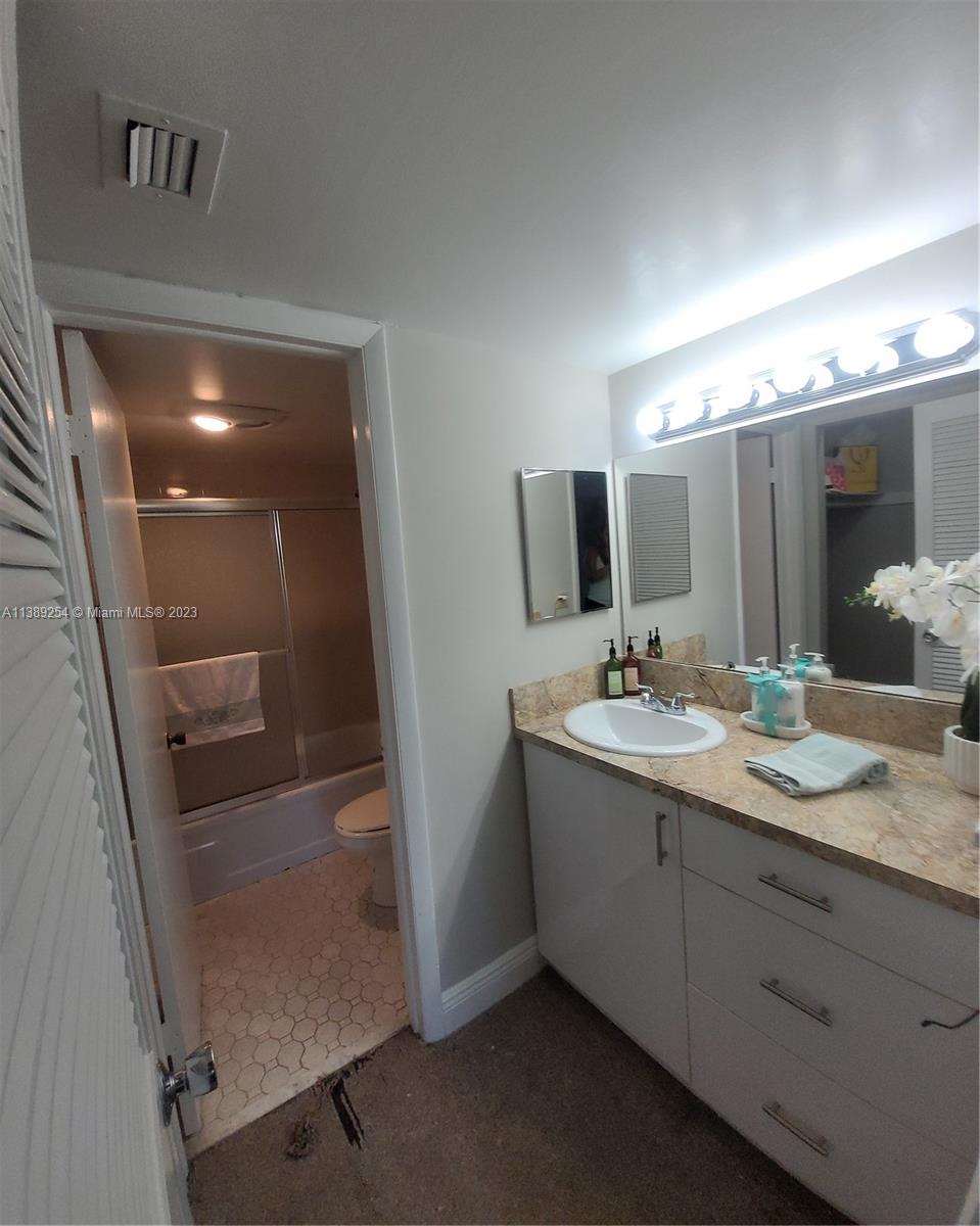 3490 Foxcroft Road, Unit B202 Miramar, FL 33025 - Photo 23 of 29 a bathroom with a double vanity sink and mirror