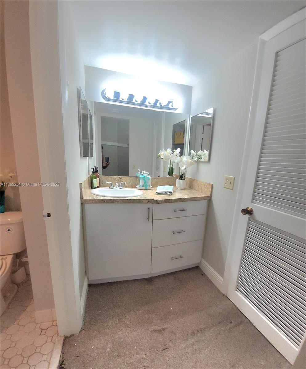 3490 Foxcroft Road, Unit B202 Miramar, FL 33025 - Photo 24 of 29 a bathroom with a sink and a mirror