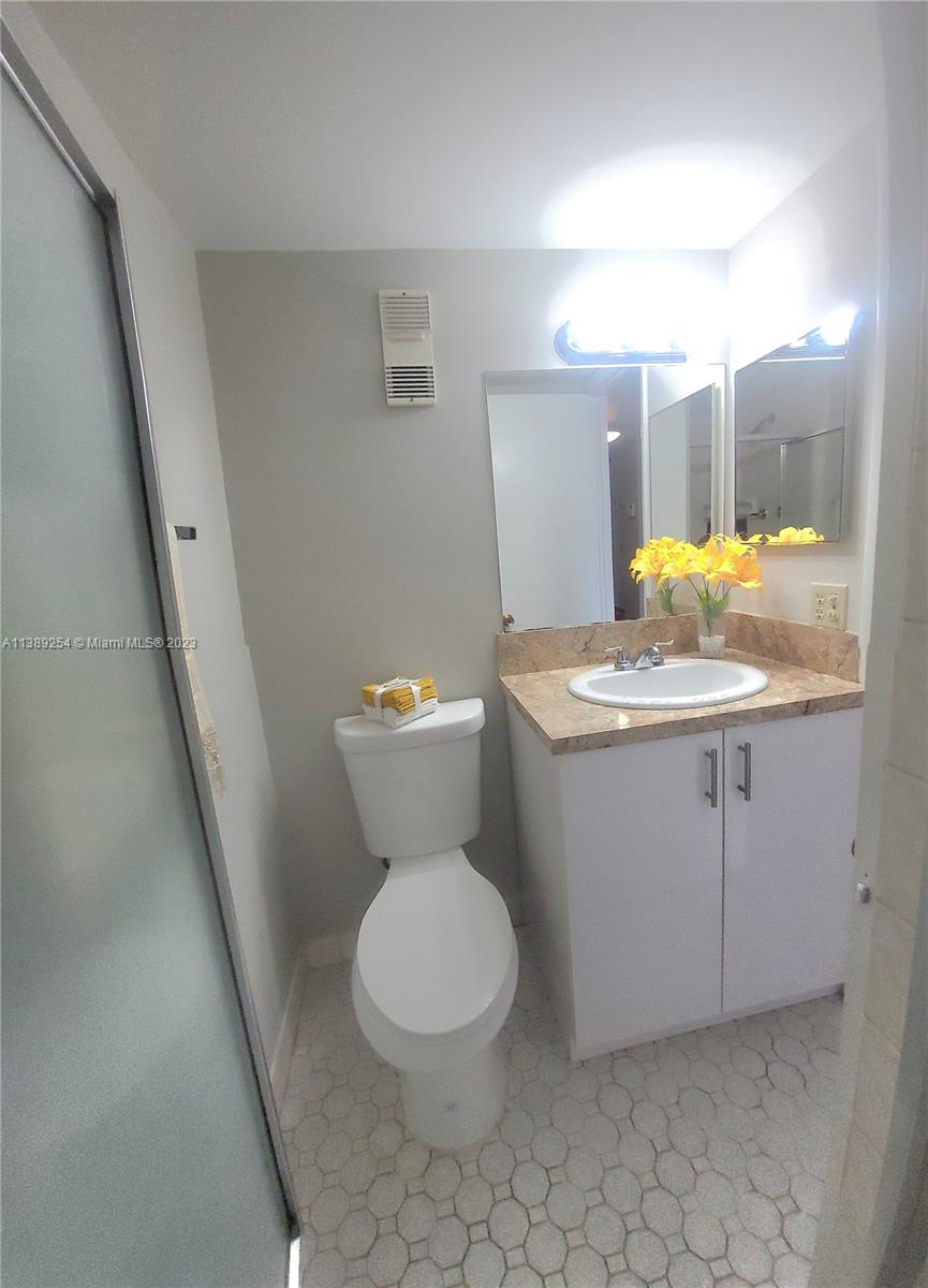 3490 Foxcroft Road, Unit B202 Miramar, FL 33025 - Photo 27 of 29 a bathroom with a sink toilet and mirror