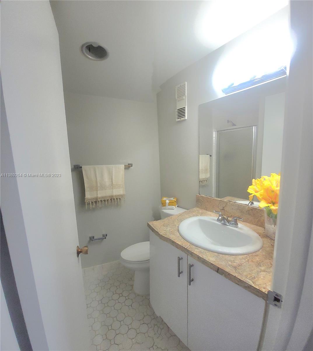 3490 Foxcroft Road, Unit B202 Miramar, FL 33025 - Photo 29 of 29 a bathroom with a sink toilet and mirror