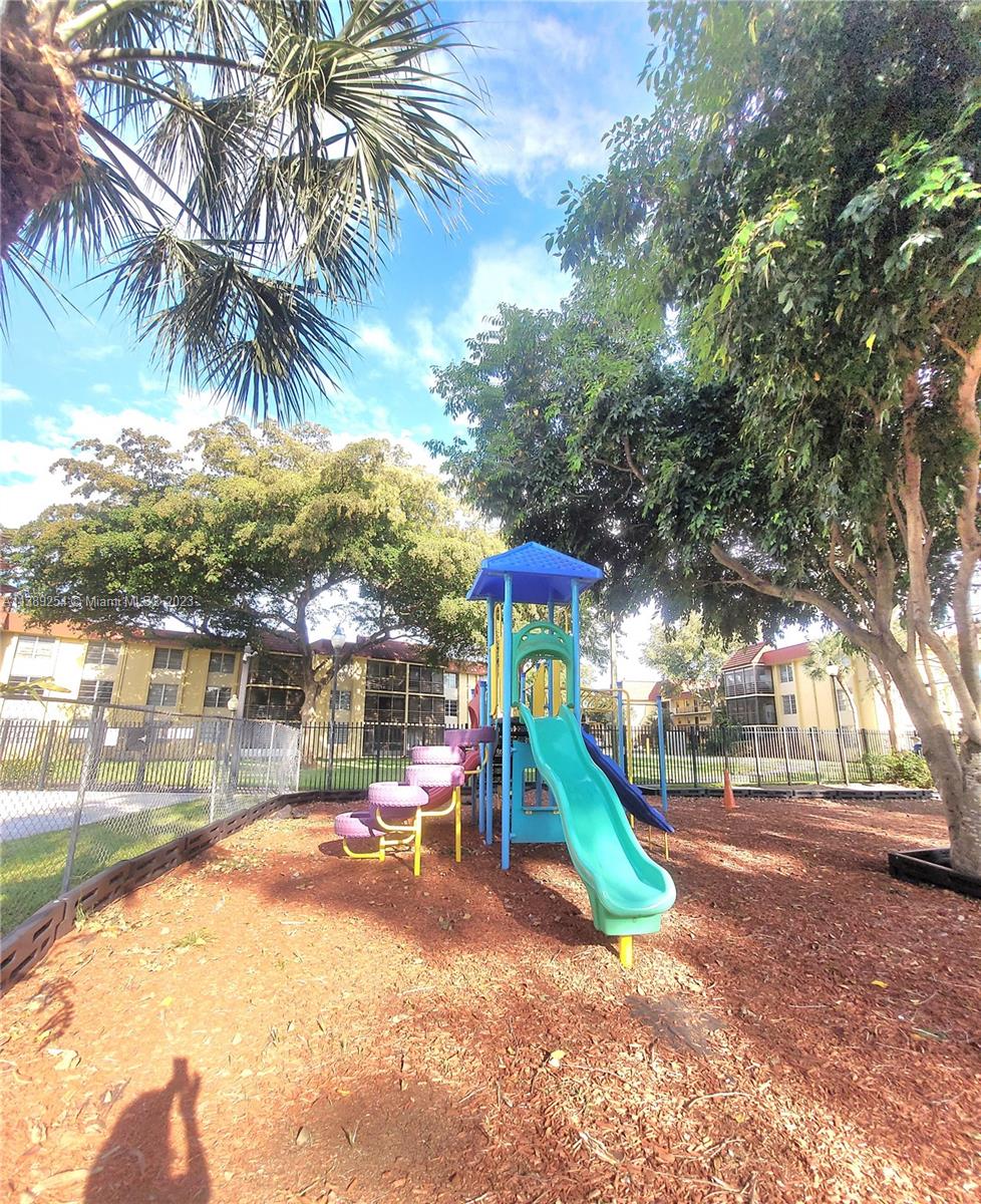 3490 Foxcroft Road, Unit B202 Miramar, FL 33025 - Photo 6 of 29 a view of a park with palm trees