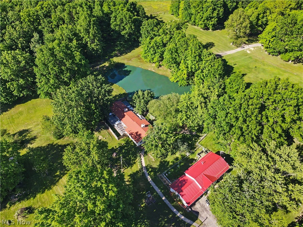 4250 Herr Fieldhouse Road Southington, OH 44470 - Photo 48 of 50 Aerial perspective of a verdant property featuring two structures with red roofs