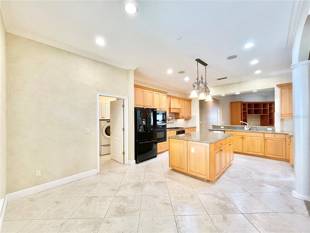 1501 Northwest 98 Street Gainesville, FL 32606 - Photo 11 of 92 a large kitchen with granite countertop a large counter top and stainless steel appliances