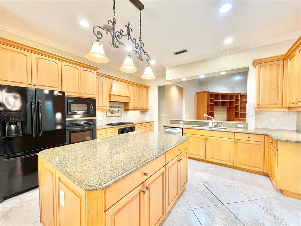 1501 Northwest 98 Street Gainesville, FL 32606 - Photo 5 of 92 a kitchen with stainless steel appliances granite countertop a sink counter space cabinets and appliances