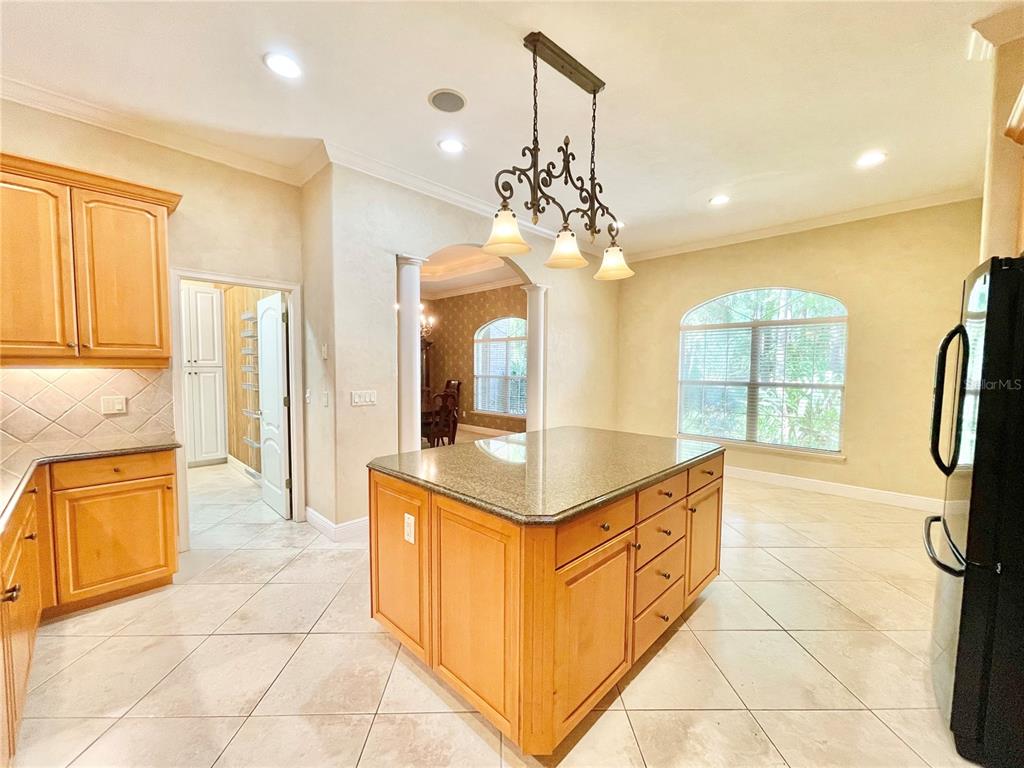 1501 Northwest 98 Street Gainesville, FL 32606 - Photo 6 of 92 a kitchen with stainless steel appliances granite countertop a sink and a refrigerator