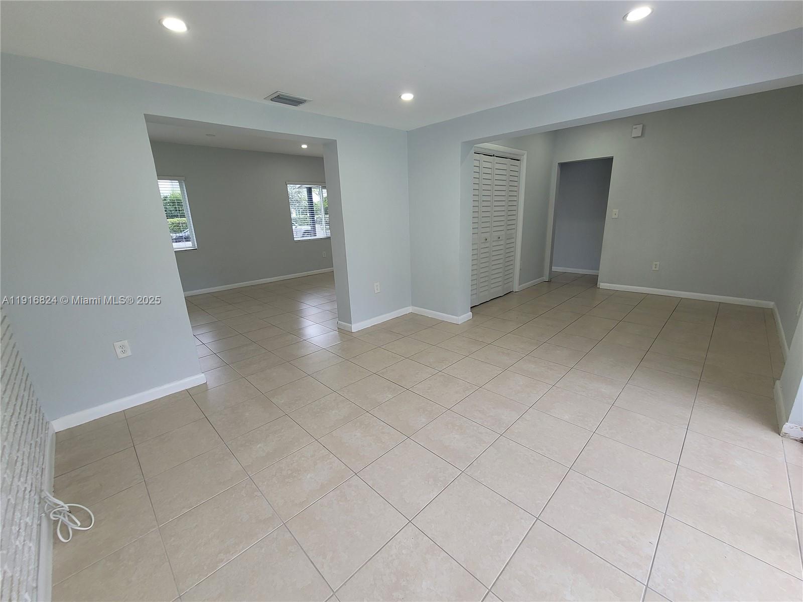 8839 Southwest 28th Street Miami, FL 33165 - Photo 14 of 29 an empty room with windows and entrance