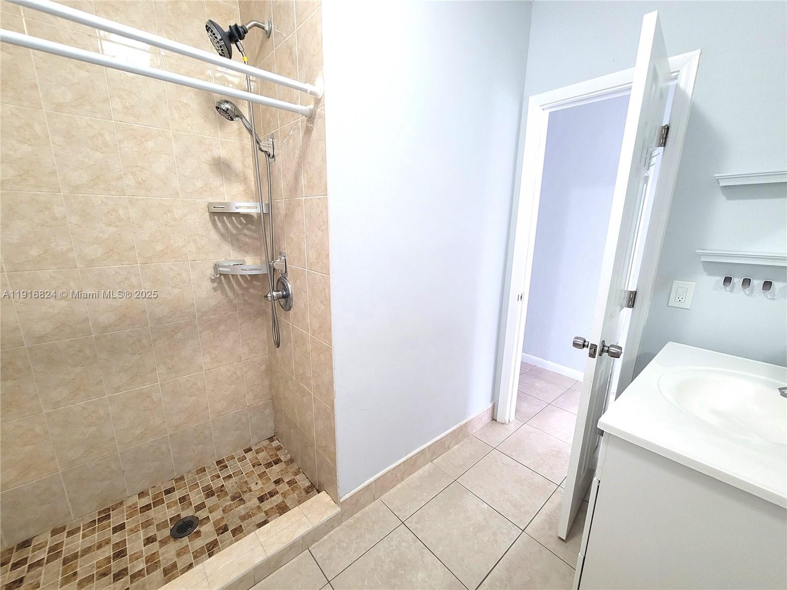 8839 Southwest 28th Street Miami, FL 33165 - Photo 17 of 29 a bathroom with a sink and a shower